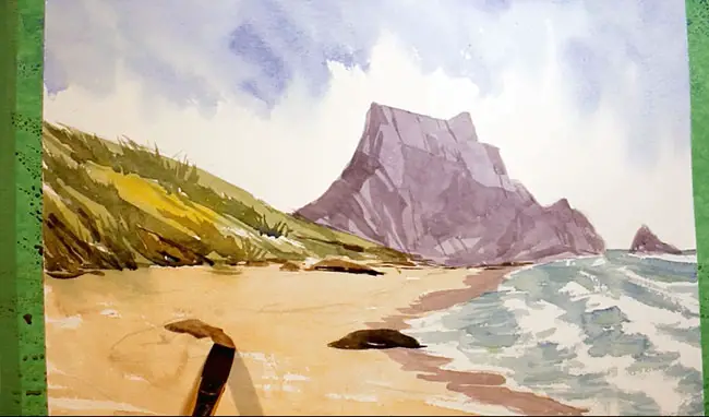Painting the foreground rocks with a flat brush and a mixture of violet and brunt umber