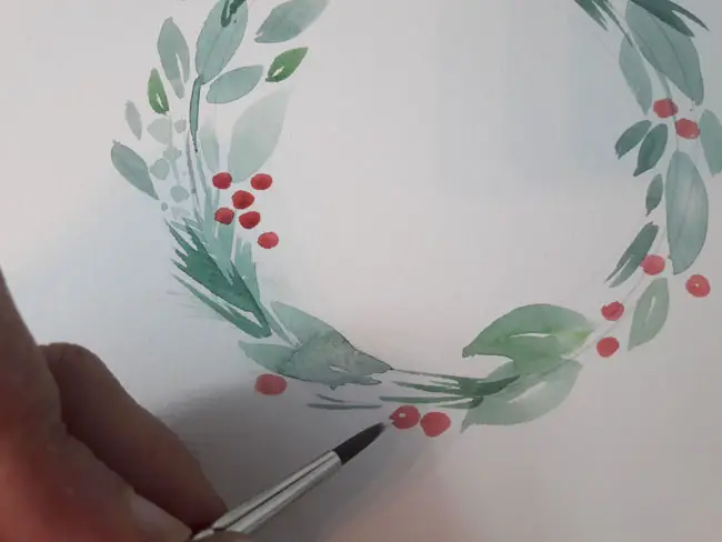 Adding highlights to the holly berries